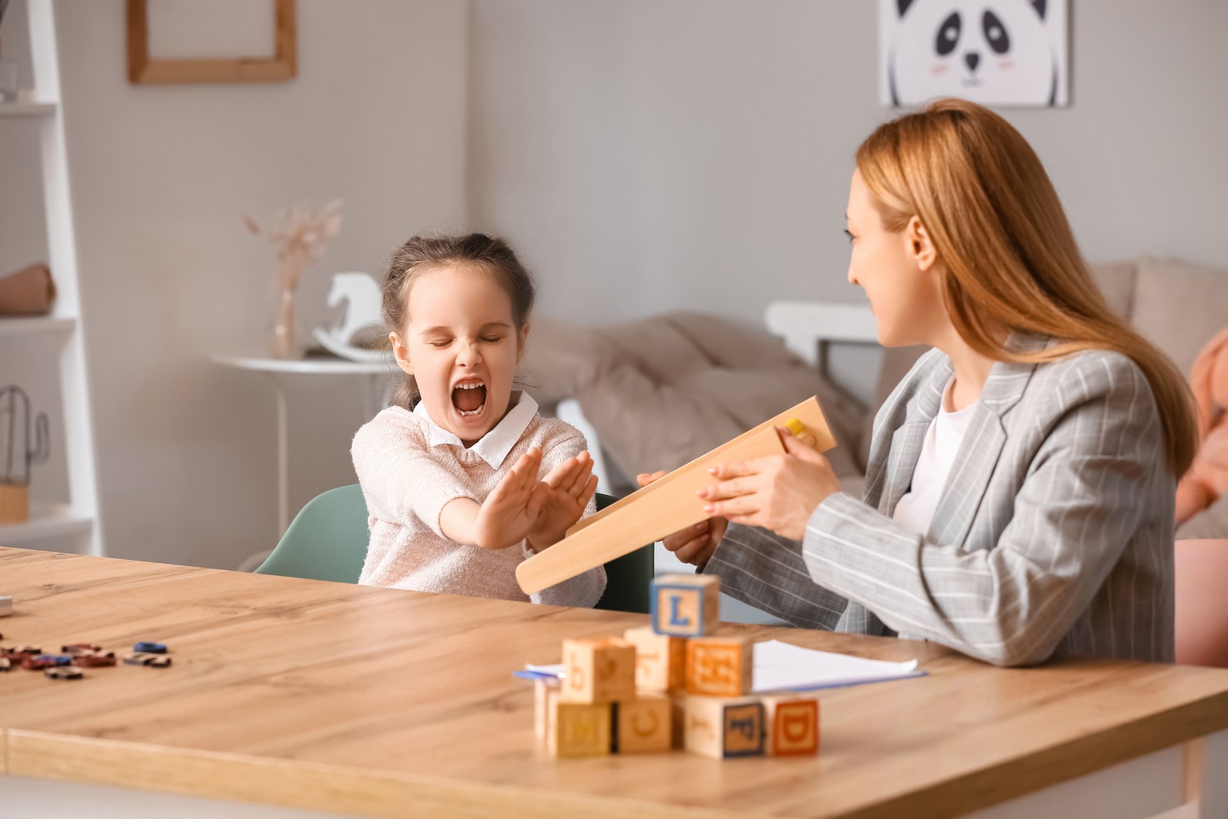 Angry Little Girl with Autistic Disorder at Child Psychologist's Office