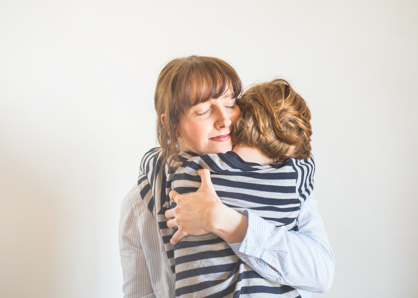 Young mother and child hugging. Mothers day